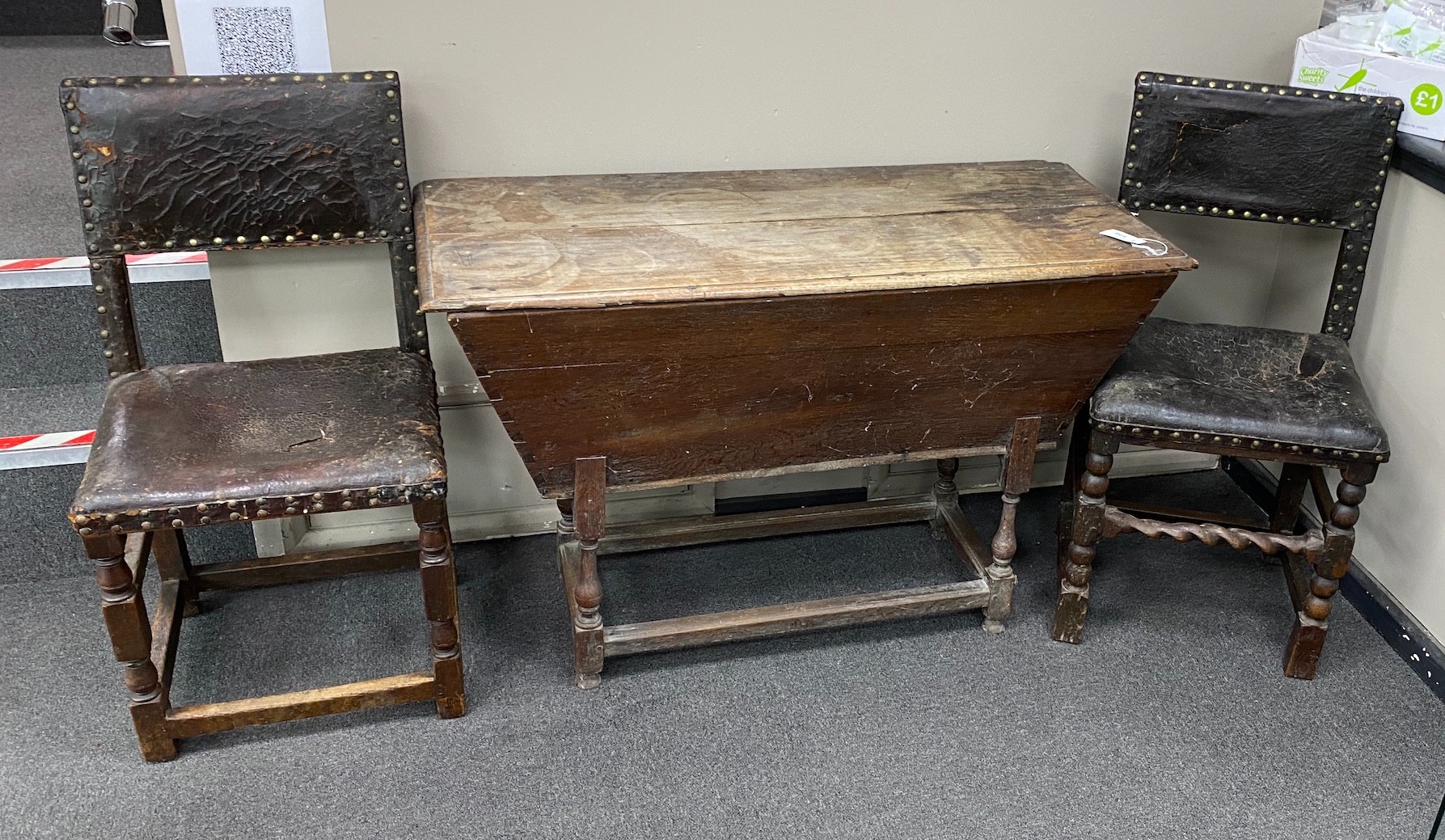 A harlequin set of six 17th century oak and leather dining chairs